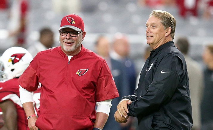 Arizona Cardinals coach Bruce Arians, left, talks with Oakland Raiders coach Jack Del Rio before an NFL preseason football game, Friday, Aug. 12, in Glendale.