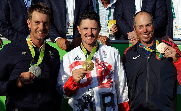 The medalists are seen from left, silver medalist Henrik Stenson of Sweden, gold medalist Justin Rose of Great Britain, and bronze medalist Matt Kuchar of the United States, after the final round of the men’s golf event at the 2016 Summer Olympics in Rio de Janeiro, Brazil, Sunday, Aug. 14.