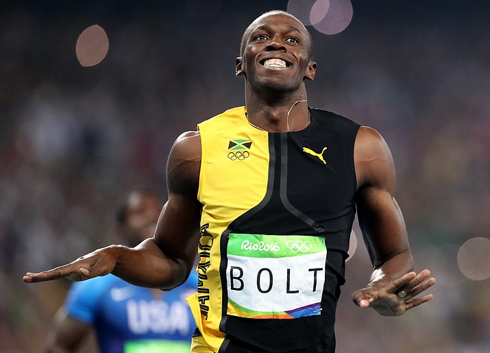 Jamaica's Usain Bolt celebrates as he crosses the line to win gold in the men's 100-meter final during the athletics competitions of the 2016 Summer Olympics at the Olympic stadium in Rio de Janeiro, Brazil, Sunday, Aug. 14.

