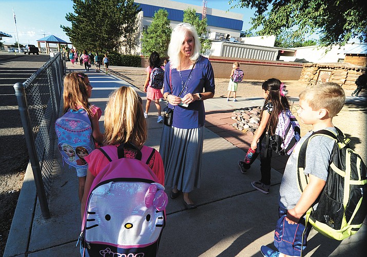Del Rio Elementary School Principal Carolyn Reeder (center) greets students arriving for the first day of classes on Tuesday, Aug. 9.