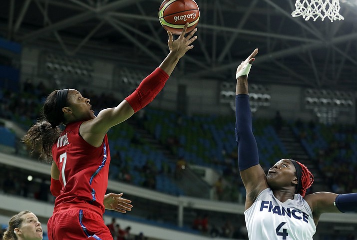 United States’ Maya Moore, left, shoots over France’s Isabelle Yacoubou, right, during a semifinal game Thursday in Rio de Janeiro, Brazil. (Charlie Neibergall/Associated Press)
