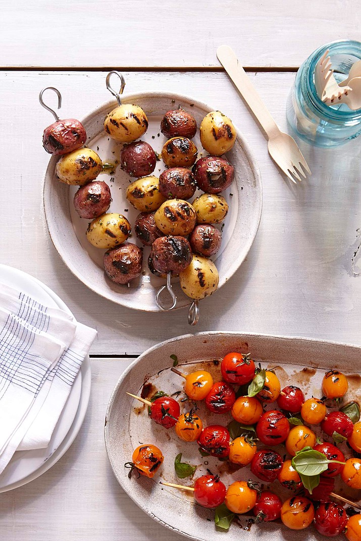 Grilled skewered cherry tomatoes and skewered red potatoes.