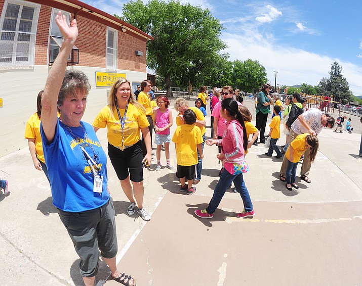 Staff wave and say goodbye to students on the last day of school at Miller Valley School in Prescott in May 2015.