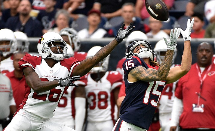 Houston Texans wide receiver Will Fuller (15) reaches for a pass in front of Arizona Cardinals cornerback Brandon Williams (26) on Aug. 28 in Houston. Fuller dropped the ball.