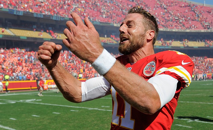 Kansas City Chiefs quarterback Alex Smith (11) celebrates after he scored the winning touchdown against the San Diego Chargers in overtime in an NFL football game in Kansas City, Mo., Sunday, Sept. 11. The Kansas City Chiefs won 33-27. 
