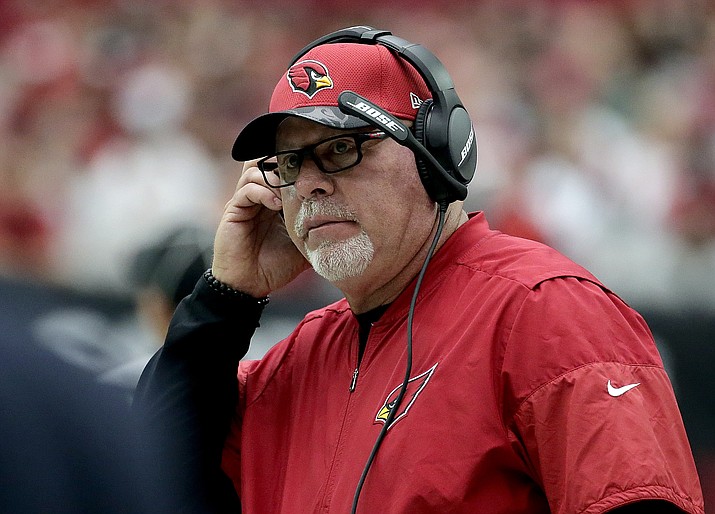 Arizona Cardinals head coach Bruce Arians makes a call against the Tampa Bay Buccaneers during the first half Sunday in Glendale. Arizona won 40-7.