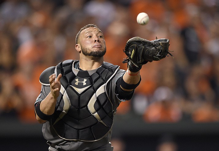 Arizona Diamondbacks catcher Welington Castillo makes a catch on a bunt pop up by Baltimore Orioles' Michael Bourn for the out during the ninth inning of a baseball game, Friday, Sept. 23, 2016, in Baltimore. The Orioles won 3-2 in 12 innings.