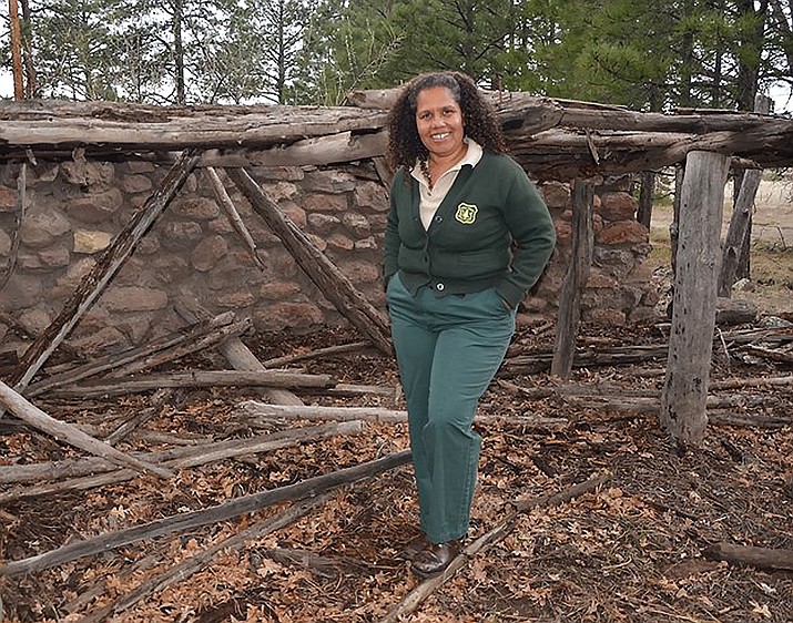Kaibab National Forest archaeologist Margaret Hangan stands in front of a prehistoric ruin. 