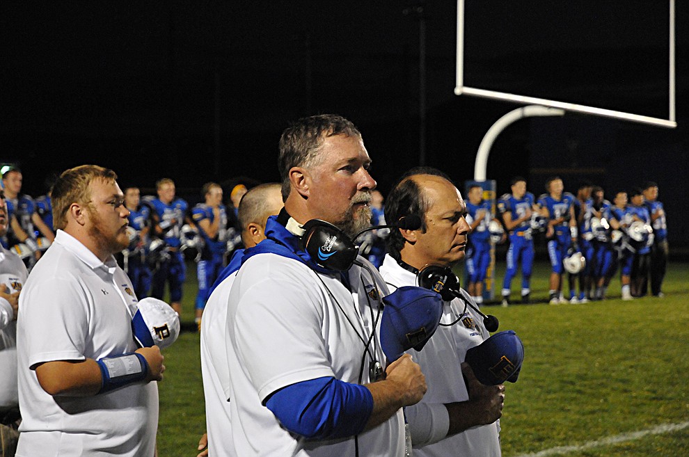 Prescott football head coach Michael Gilpin, center, stands with his coaching staff during the national anthem at homecoming Friday, Sept. 30. Prescott (4-2, 2-0 4A Grand Canyon) earned a 43-14 win over Mohave. (Brian M. Bergner Jr./The Daily Courier)