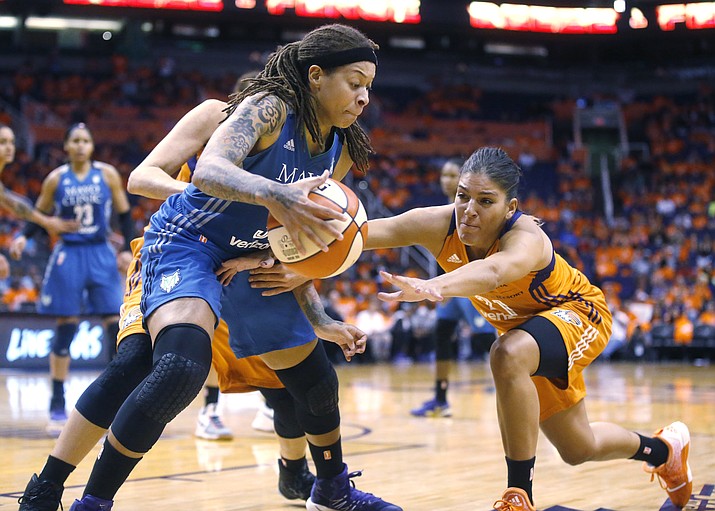 Phoenix Mercury Marta Xargay, right, attempts to steal the ball from Minnesota Lynx Seimone Augustus during game 3 of the WNBA basketball semifinals in Scottsdale, Sunday, Oct. 2.