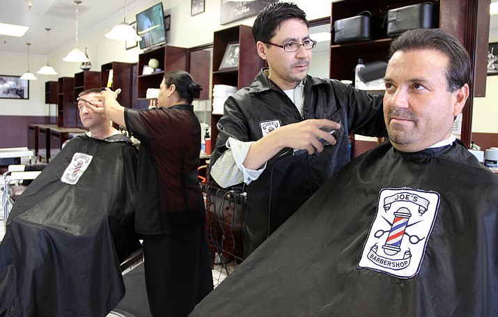Johan Bieberach, owner of Joe’s Barbershop, trims Jayme Salazar’s hair. Salazar is a regular customer of Bieberach’s. 