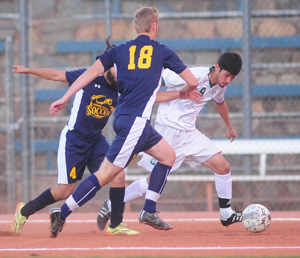 Yavapai's David Gandara battles with a pair of defenders as the Roughriders host Phoenix College in a soccer matchup Thursday, October 6, 2017 in Prescott. (Les Stukenberg/The Daily Courier Photo)