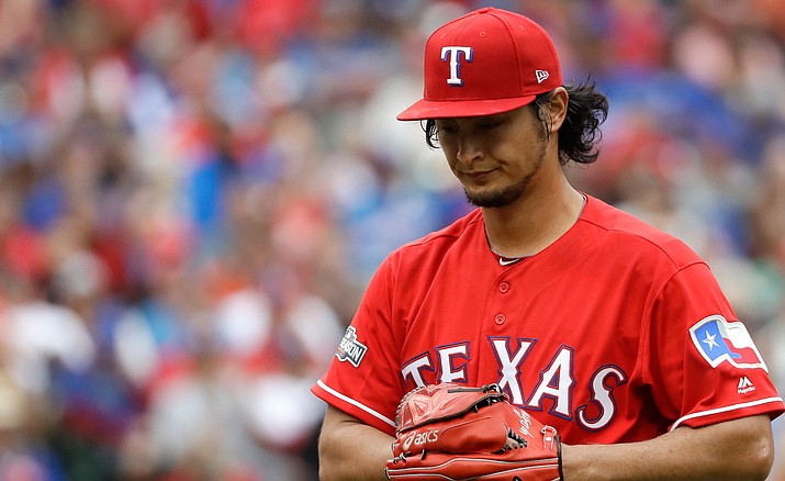 Texas Rangers pitcher Yu Darvish, of Japan, walks to the dugout during the fifth inning of Game 2 of baseball's American League Division Series against the Toronto Blue Jays , Friday, Oct. 7, in Arlington, Texas.