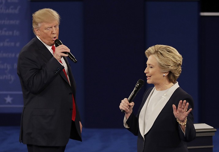 Republican presidential nominee Donald Trump and Democratic presidential nominee Hillary Clinton speak during the second presidential debate at Washington University in St. Louis, Sunday, Oct. 9.
