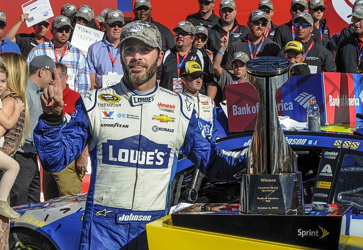 Jimmie Johnson celebrates in Victory Lane after winning a NASCAR Sprint Cup Series auto race, Sunday, Oct. 9, at Charlotte Motor Speedway in Concord, N.C.
