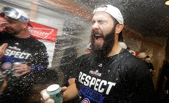 Chicago Cubs pitcher Jake Arrieta celebrates with teammates in the locker room after Game 4 of baseball's National League Division Series against the San Francisco Giants in San Francisco, Tuesday, Oct. 11. The Cubs won 6-5.