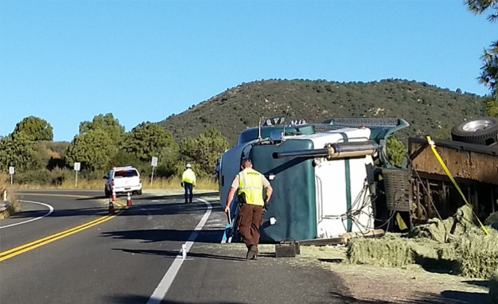 This double-trailer load of hay overturned on Iron Springs Road on Tuesday. Its driver, Tommy Baysinger, 60, from Arizona, faces DUI and drug charges.