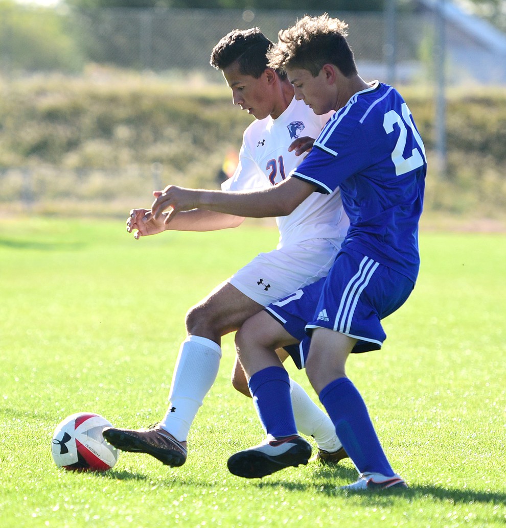 Chino Valley's Abraham Parada (21) battles for the ball with Liam Cashmore (20) as the Cougars take on Northland Prep Academy in Chino Valley Thursday, October 13. (Les Stukenberg/The Daily Courier)