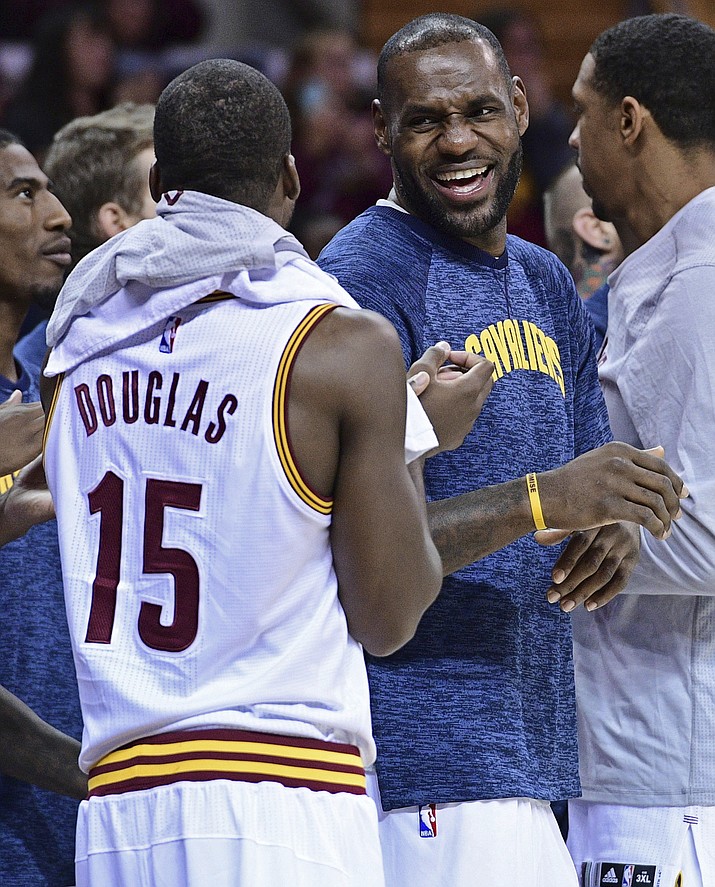 Cleveland Cavaliers forward LeBron James (23) laughs with guard Toney Douglas (15) during the second half of an NBA preseason basketball game in Cleveland. NBA Commissioner Adam Silver and James are openly expressing their optimism for the NBA and its players being able to strike a new labor deal in the coming weeks.