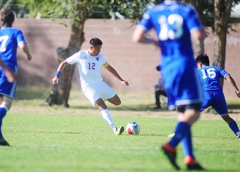 Chino Valley's Edgar Sanchez (12) passes the ball between a trio of defenders as the Cougars take on Northland Prep Academy in Chino Valley Thursday, October 13. (Les Stukenberg/The Daily Courier)