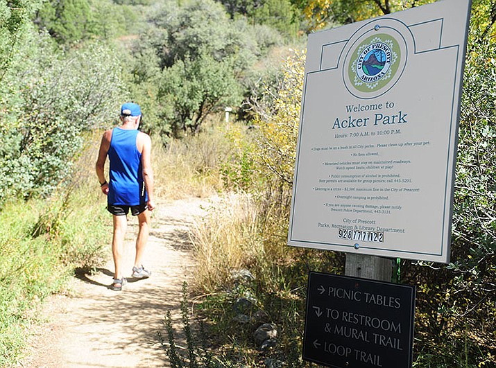 Randy Schurr heads out on his daily hike at Acker Park Friday morning. 