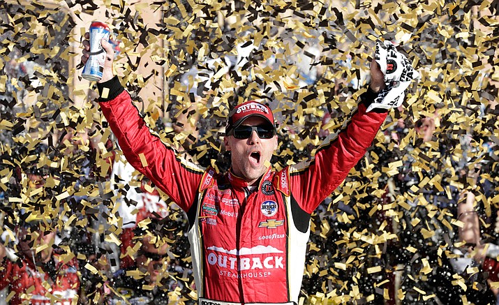 NASCAR driver Kevin Harvick celebrates in victory lane after winning a Sprint Cup series auto race at Kansas Speedway in Kansas City, Kan., Sunday, Oct. 16.
