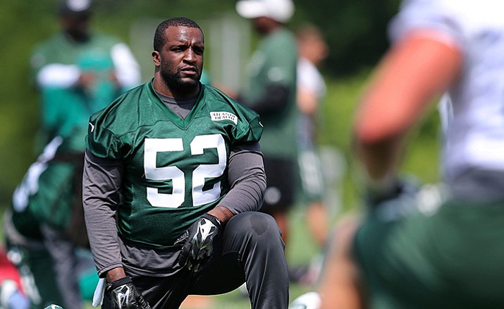In this Wednesday, June 1, 2016, file photo, New York Jets linebacker David Harris (52) stretches during NFL football practice in Florham Park, N.J. Harris was listed Saturday, Oct. 15, as doubtful to play against the Arizona Cardinals on Monday night because of a hamstring injury, putting his streak of 121 consecutive games played in jeopardy. 