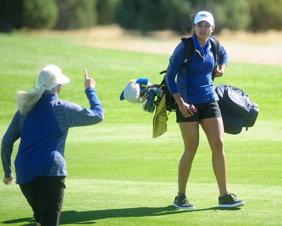 Embry Riddle Head Golf Coach Kim Haddow, at left, talks with Lauren Kruszewski on the first hole Monday during the Embry-Riddle Invitational at Talking Rock Golf Club in Prescott.