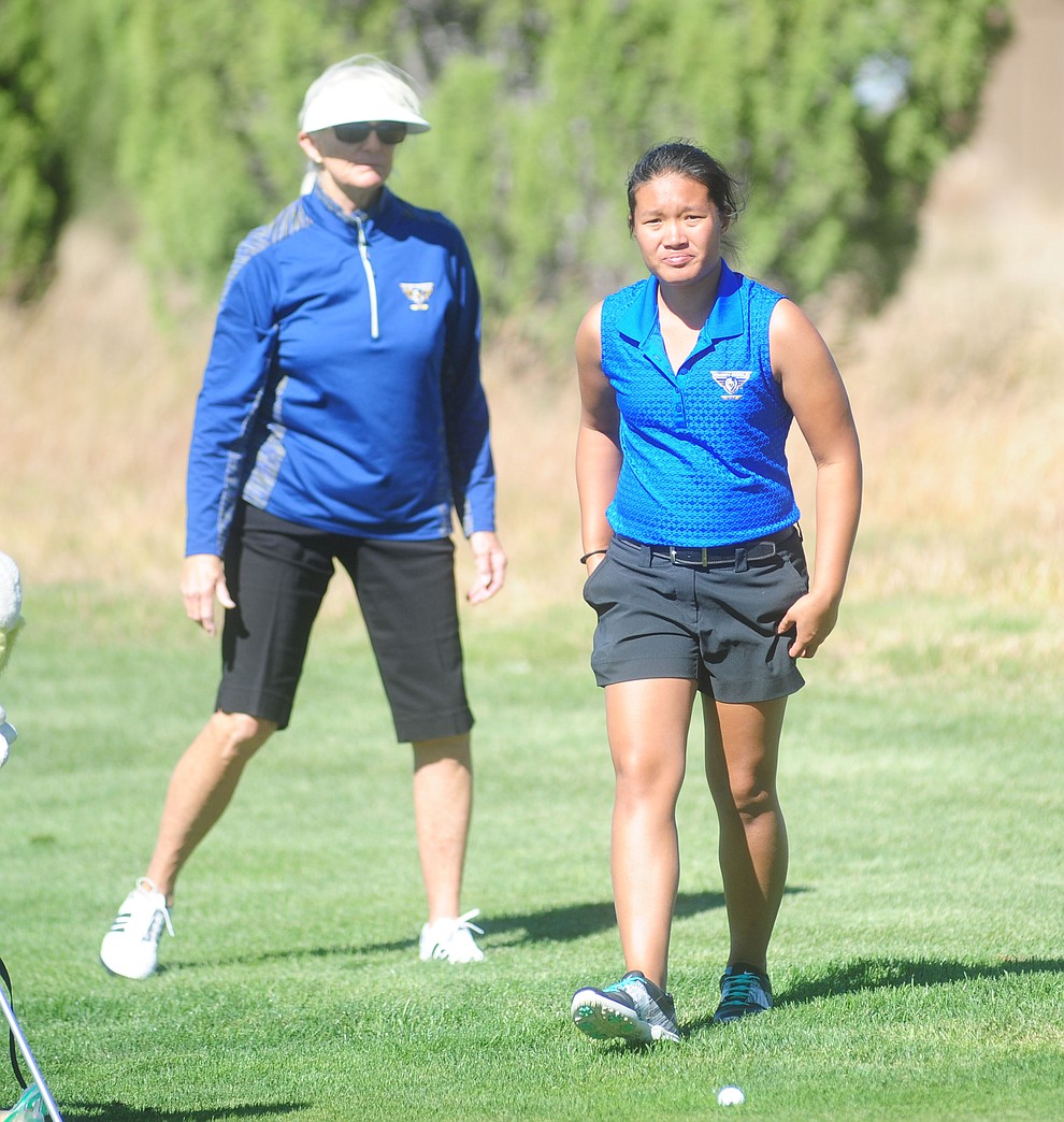 Embry Riddle's Nicole Lopes heads for her bag as head coach Kim Haddow watches Monday during the Embry-Riddle Invitational at Talking Rock Golf Club in Prescott.