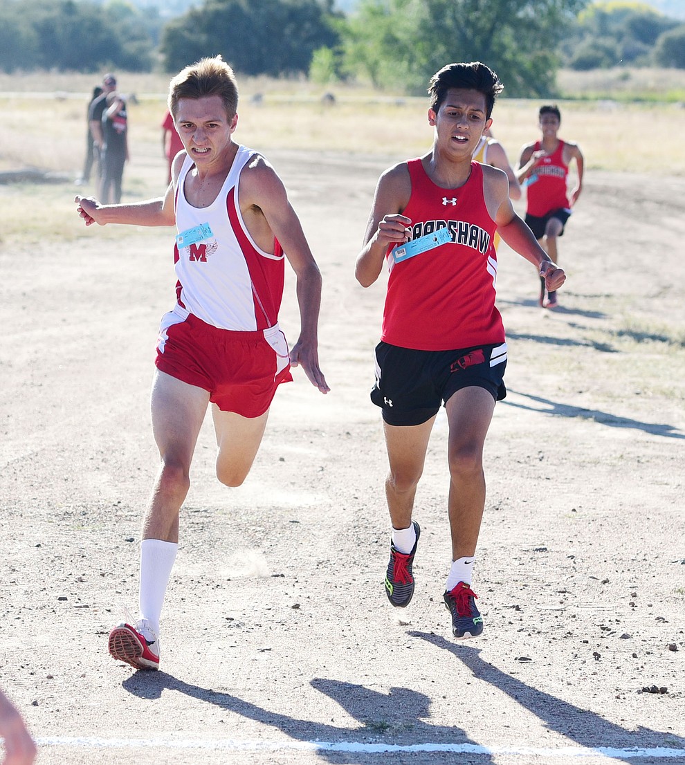 Mingus Union's Ryan Alexander edges out Bradshaw Mountain's David Villagran for third during the Yavapai County Cross Country meet at Embry Riddle Aeronautical University in Prescott Wednesday, October 19.