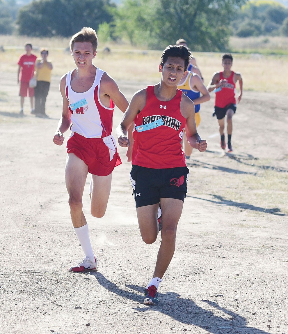 Bradshaw Mountain's David Villagran and Mngus' Ryan Alexander battle for third during the Yavapai County Cross Country meet at Embry Riddle Aeronautical University in Prescott Wednesday, October 19.