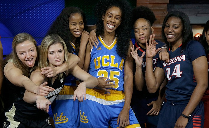 Colorado's Kennedy Leonard, from left, poses for photos with teammate Lauren Huggins, UCLA's Jordin Canada and Monique Billings, and Arizona's Malena Washington and LaBrittney Jones during NCAA college basketball Pac-12 media day in San Francisco, Thursday, Oct. 20. 
