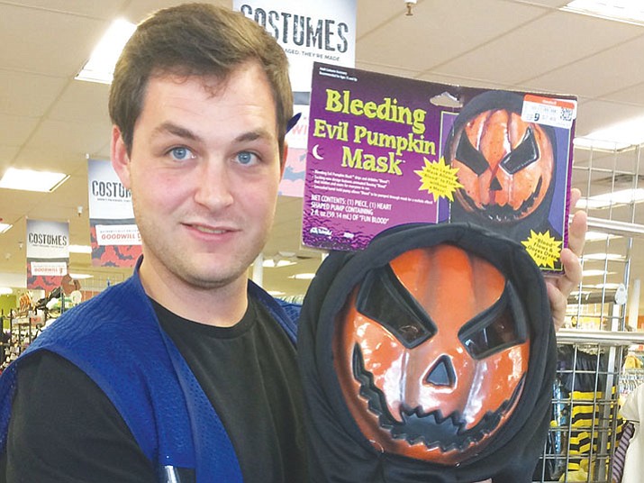 goodwill store associate trevor blish holds up a favorite pumpkin head mask - Halloween Stores In Az goodwill store associate trevor blish holds up a favorite pumpkin head mask - Halloween Stores In Az