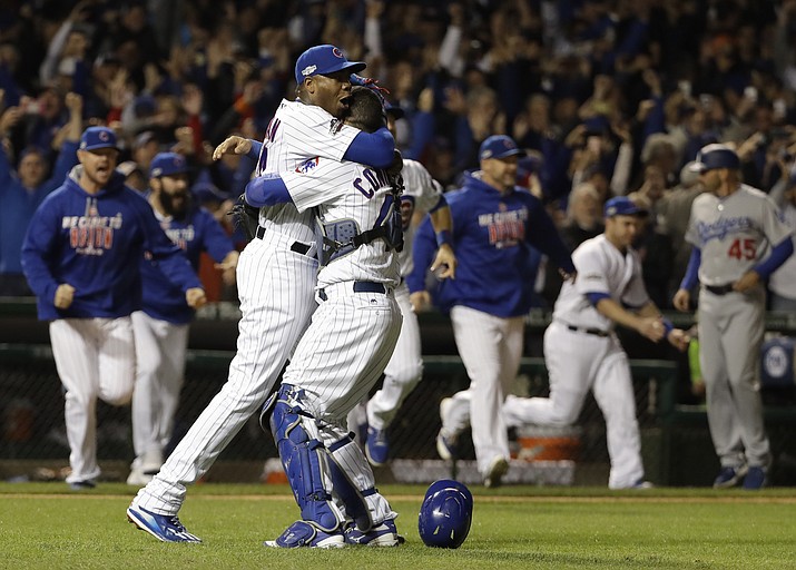 Chicago Cubs catcher Willson Contreras and relief pitcher Aroldis Chapman (54) celebrate after Game 6 of the National League baseball championship series against the Los Angeles Dodgers Saturday, Oct. 22, 2016, in Chicago. The Cubs won 5-0 to win the series and advance to the World Series against the Cleveland Indians. 