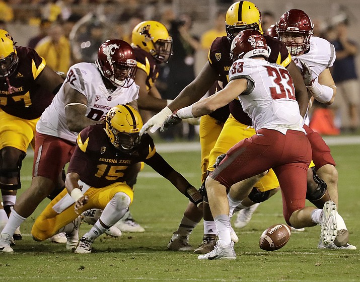 Arizona State quarterback Dillon Sterling-Cole (15) fumbles the football as Washington State defensive lineman Dylan Hanser (33) and nose tackle Robert Barber (92) defend during the second half of an NCAA college football game, Saturday, Oct. 22, 2016, in Tempe, Ariz. Washington recovered the ball. 