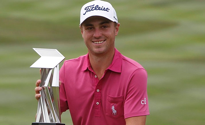 Justin Thomas of the United States poses with his trophy after winning the CIMB Classic golf tournament at Tournament Players Club (TPC) in Kuala Lumpur, Malaysia, Sunday, Oct. 23.