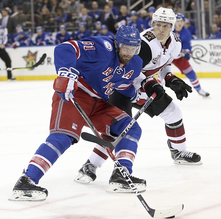 New York Rangers' Rick Nash, left, and Arizona Coyotes' Jakob Chychrun compete for the puck during the second period of an NHL hockey game, Sunday, Oct. 23, in New York. 
