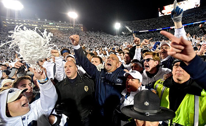 Penn State coach James Franklin, center, celebrates with the crowd after the team's 24-21 win over Ohio State during an NCAA college football game Saturday, Oct. 22, in State College, Pa.