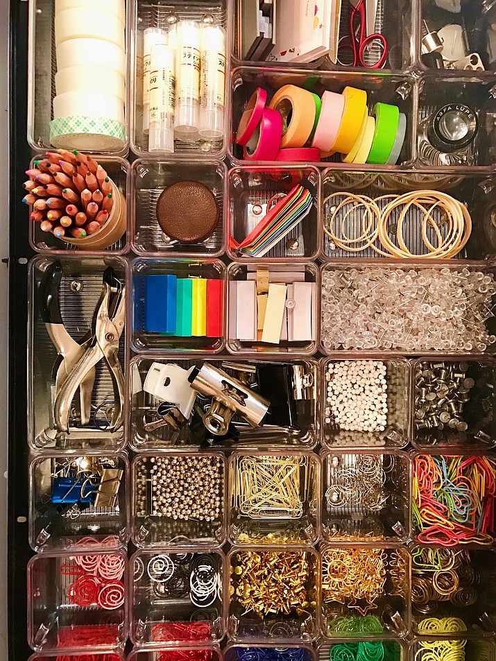 This undated photo provided by Darcy Miller shows one of her crafting drawers filled with tiny containers holding everything from color-coded paperclips to washi tape -- some of the items she reaches for most. Miller, editor at large for "Martha Stewart Weddings," says art project clean up is easier if supplies are kept organized. When Miller is in the midst of a project, the room gets disheveled. "If you could see what it looks like right now â€¦" Miller says, noting she'd recently hosted a daughter's crafting birthday party. (Darcy Miller/www.darcymillerdesigns.com via AP)