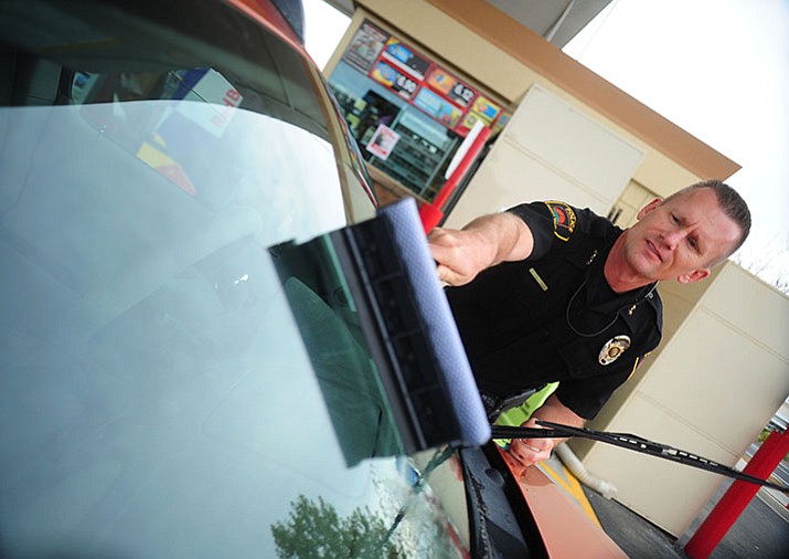 Deputy Chief James Edelstein gets into the act by cleaning windows of those who donated money as members of the Prescott Valley Police Department raise money for the Special Olympics at the Glassford Hill Fry’s Store gas pumps Thursday, October 27. The officers raised approximately $2100, according to Sgt. Jason Kaufman.
