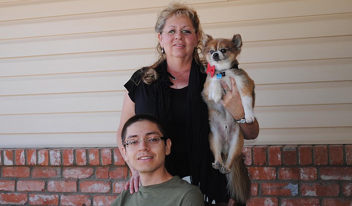 Rachel Hernandez, Jaime Valenzuela, and Sam the dog pose for a picture in front of the Hernandez’s mother’s home. Hernandez, a fourth-generation Verde Valley resident, is the Verde Valley Habitat for Humanity’s newest home owner. (VVN/Jennifer Kucich)