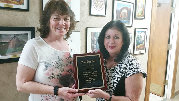 Julie Keeney (left), Hospice of the Pines, presents Julie Robins with this month’s Hometown Hero of the Month award. (Courtesy photo)