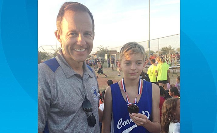 Coach Mark Colbert and Nic Colbert after Nic received his 10th-place medal in the Arizona Middle School State Championship race. (Courtesy photo)