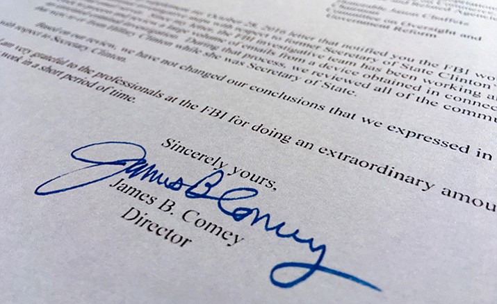 Part of a Nov. 6, 2016, letter from FBI director James Comey to Congress is photographed in Washington, Sunday, Nov. 6, 2016. Comey tells Congress that a review of new Hillary Clinton emails has "not changed our conclusions" from earlier this year that she should not face charges. 