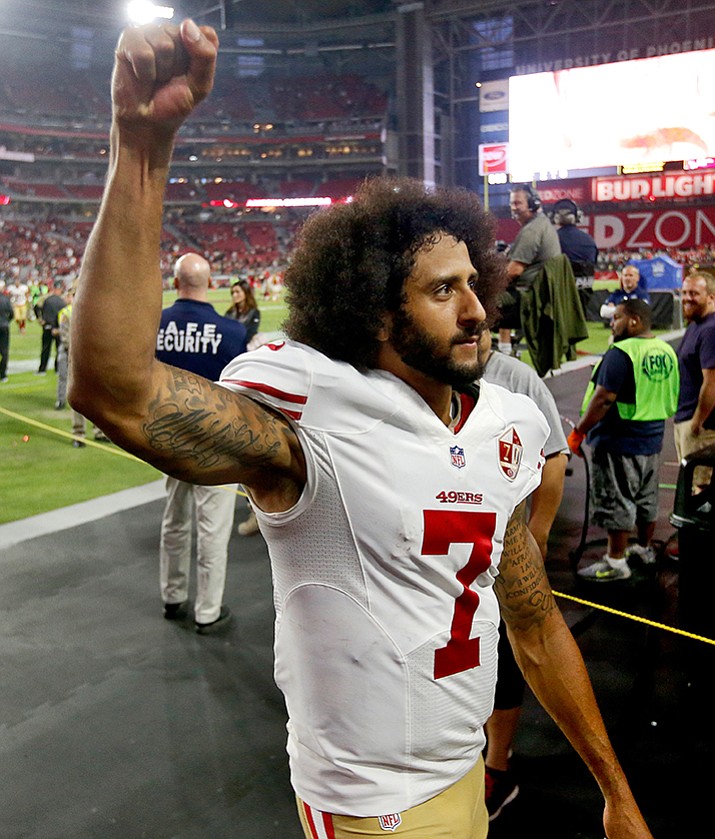 San Francisco 49ers quarterback Colin Kaepernick (7) makes a fist as he is booed by fans after an NFL football game against the Arizona Cardinals, Sunday, Nov. 13, in Glendale, Ariz. The Cardinals won 23-20. 