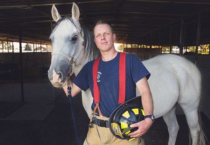 Groom Creek Fire District firefighter Daniel Boutin is pictured in the 2017 Heroes and Hounds Calendar with Skipper the horse who entered YHS’s Equine Program in July and is looking for his forever home. 