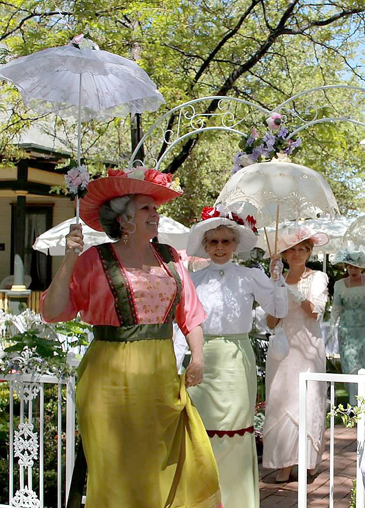 Three members of the Elks Opera House Guild, with their parasols, partake of a Victorian Tea during warmer weather this year.