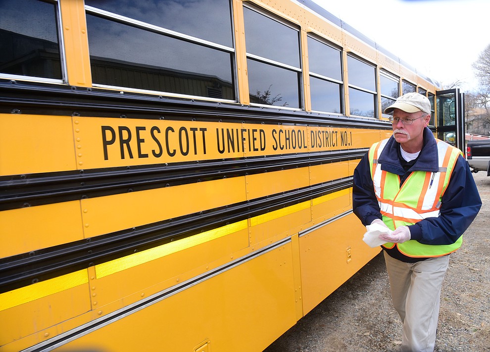 Prescott Unified School District Transportation Department's field trip and route coordinator Paul Beaumont checks his bus before going out on the afternoon run for route 11 Thursday, Dec. 1 in Prescott. (Les Stukenberg/The Daily Courier)