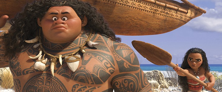 Maui, voiced by Dwayne Johnson, left, and Moana, voiced by Auli'i Cravalho, in a scene from Disney’s new animated film, "Moana." 