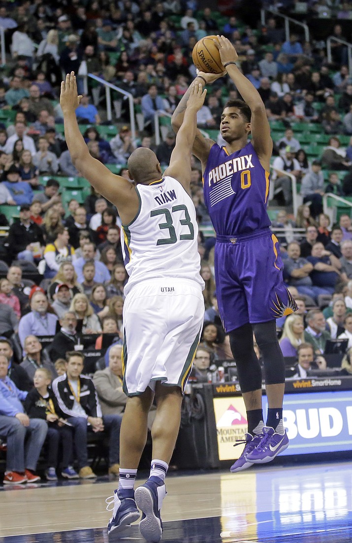 Phoenix Suns forward Marquese Chriss (0) shoots as Utah Jazz center Boris Diaw (33) defends in the first half of an NBA basketball game, Tuesday, Dec. 6, 2016, in Salt Lake City.